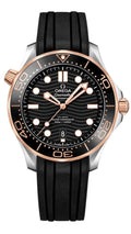Omega Seamaster Submariner Date watch with a black dial, black bezel, and black rubber strap, featuring a silver-toned stainless steel case with rose gold accents on the case and crown.